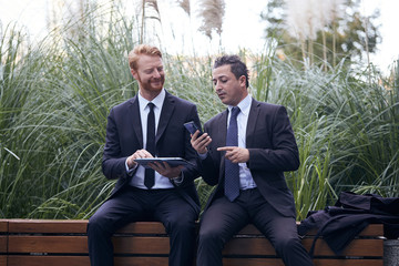 business people working outside office building