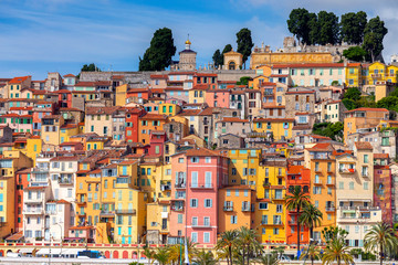 Fototapeta na wymiar Menton. Antique multi-colored facades of medieval houses on the shore of the bay.