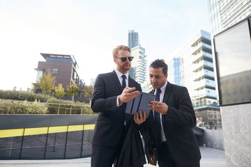 business people working outside office building