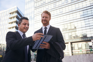 business people working outside office building