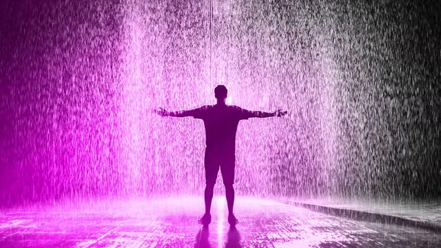 Cinemagraph of man standing in shower of pink rain