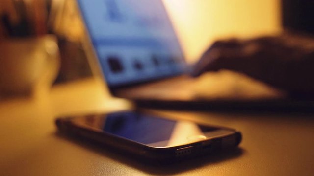defocused hands typing on laptop. shot i slow motion