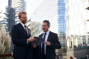 business people working outside office building