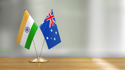 Australian and Indian flag pair on a desk over defocused background 
