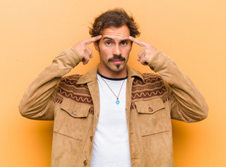 young handsome man with a serious and concentrated look, brainstorming and thinking about a...