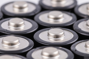 Fototapeta na wymiar Positive terminals of AA batteries with selective focus