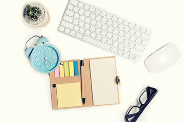 White office desk table with a lot of things on it. Top view with copy space © bank