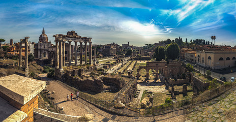 Fototapeta na wymiar Beautiful panoramic view On Roman Forum from the hill in Rome, Italy. Scenic view on Foro Romano in Rome during nice sunny weather and blue sky