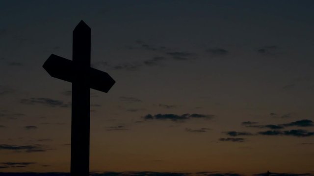 Large Christian cross at sunset
