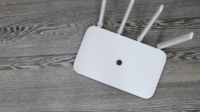 Top View White Wireless Wi-Fi Router On The Grey Desk Panning Slider Shot.
