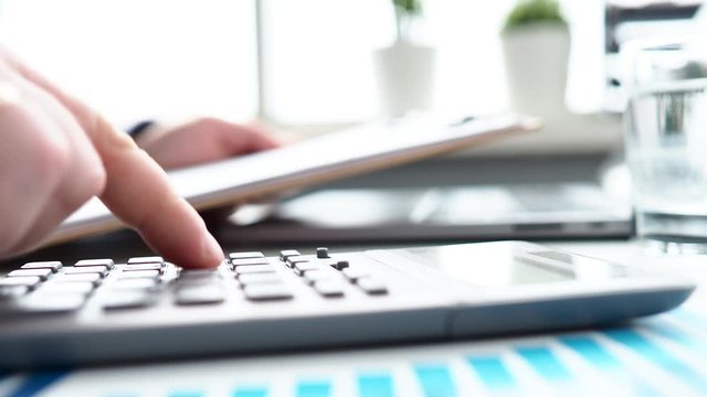 Silver calculator with gray keyboard is lying
