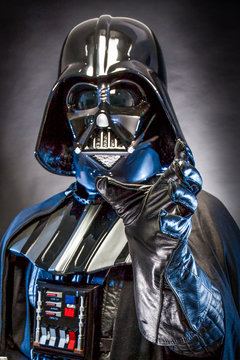 AN BENEDETTO DEL TRONTO, ITALY. MAY 16, 2015. Half-lenght portrait of Darth  Vader with grab hand . Darth Vader is a fictional character of Star Wars  saga. Black background. Blue grazing light