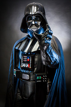 AN BENEDETTO DEL TRONTO, ITALY. MAY 16, 2015. Half-lenght portrait of Darth  Vader with grab hand . Darth Vader is a fictional character of Star Wars  saga. Black background. Blue grazing light