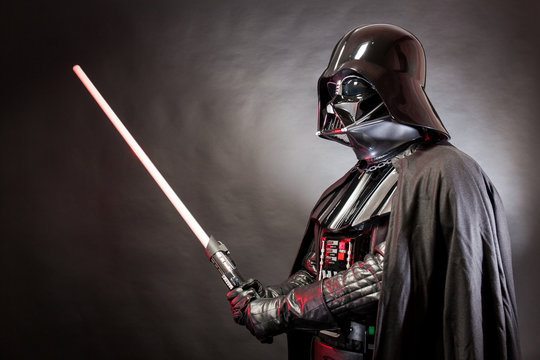 SAN BENEDETTO DEL TRONTO, ITALY. MAY 16, 2015. Portrait of Darth Vader costume replica with his sword . Darth Vader or Dart Fener is a fictional character of Star Wars saga.