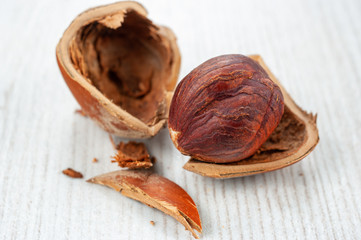 Huzelnut on wooden background.