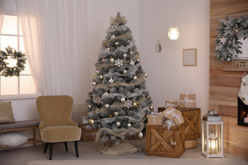 Festive interior with beautiful Christmas tree and gifts