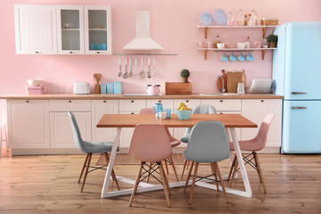 Stylish kitchen interior with dining table and chairs