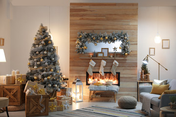 Beautiful living room interior with decorated Christmas tree and fireplace