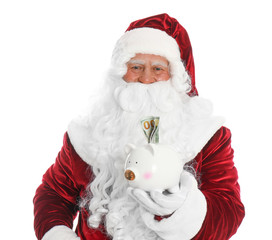 Santa Claus holding piggy bank with dollar banknotes on white background