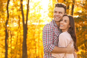 Happy couple in sunny park. Autumn walk