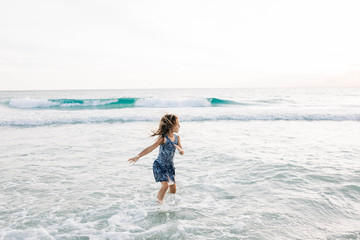 Little Girl Playing in Ocean