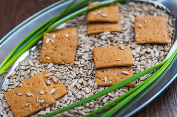 Fototapeta na wymiar wheat crackers shooted with different vegetables,groats,honey,seeds,salt on different surfaces