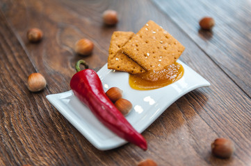 wheat crackers shooted with different  vegetables,groats,honey,seeds,salt on different surfaces