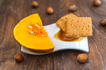 wheat crackers shooted with different  vegetables,groats,honey,seeds,salt on different surfaces