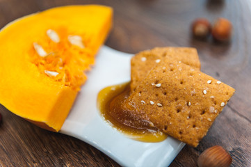 wheat crackers shooted with different  vegetables,groats,honey,seeds,salt on different surfaces