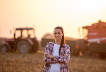 Farmer woman with crossed arms at corn harvest