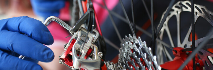 Male repair man bicycle service in blue protective