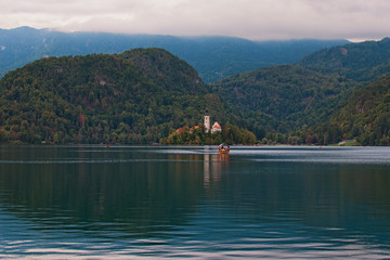 Scenic autumn landscape of Bled Lake. Majestic view of Saint Mary?s Church of Assumption on small island against mountain range. Bled Lake, the Upper Carniolan region of northwestern Slovenia