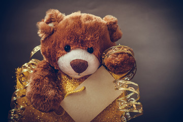 Christmas card with Teddy Bear.  With  holiday decoration and presents