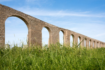 Fototapeta premium Kamares antique aqueduct in Larnaca, Cyprus. Ancient Roman aqueduct
