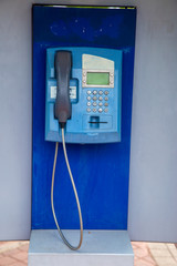 blue street phone in a booth