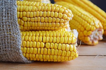 Fresh corn on a wooden background.