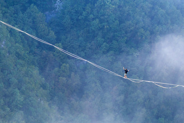 Highliner goes on a sling above the clouds.