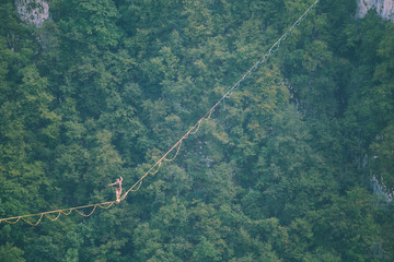 A man walks confidently along the highline.