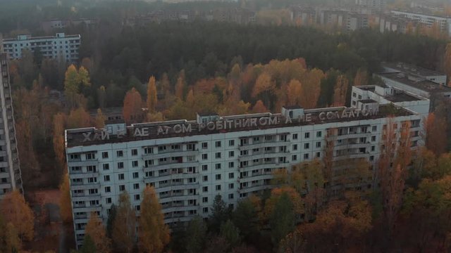 Flying near the inscription about the atom in the city of Pripyat after the accident at the Chernobyl nuclear power plant in 1986