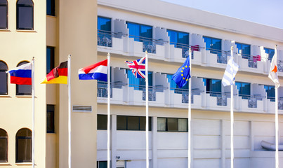 Flags on flagpoles opposite the hotel