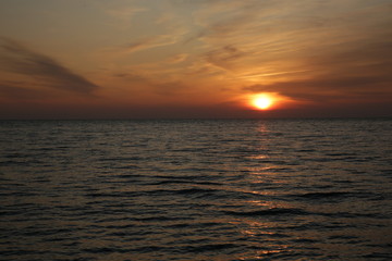sunset over the sea with reflection in the water.