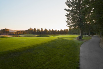 Sunset at the Golf Course - The sun sets on a putting green at the golf course in Autumn