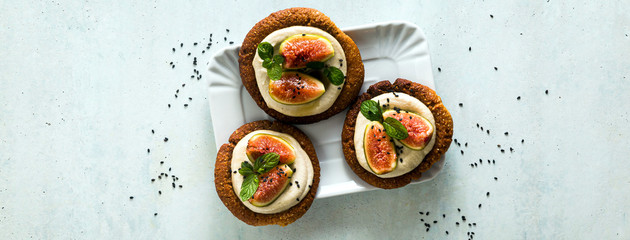 banner of healthy gluten-free vegan cakes with sesame cookie base and cashew cream. with fresh figs. healthy cuisine