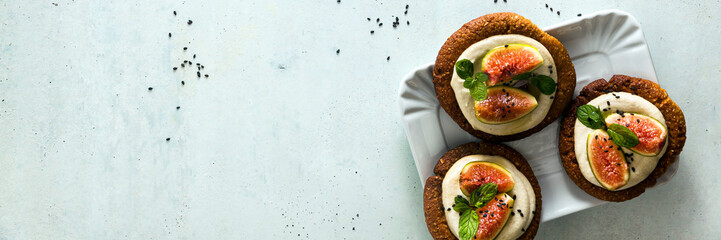 banner of healthy gluten-free vegan cakes with sesame cookie base and cashew cream. with fresh figs. healthy cuisine