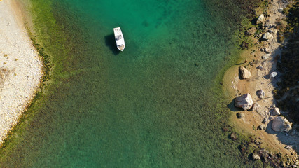 Aerial top down view of tropical exotic rocky bay with emerald sea