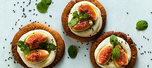 banner of healthy gluten-free vegan cakes with sesame cookie base and cashew cream. with fresh figs. healthy cuisine