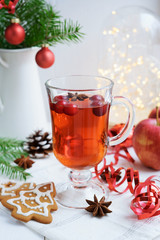 Hot beverage with cranberries and christmas cookies