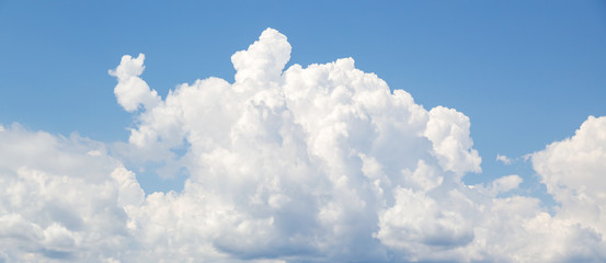 White cumulus clouds formation in blue sky