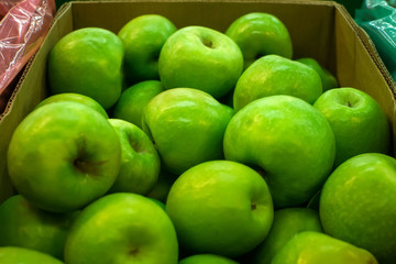 ripe green apples on the market counter