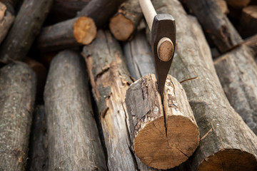 Ax stuck in the stump. wooden stump in the forest. Deforestation man. Felled tree. Woodcutter's ax on the stump.